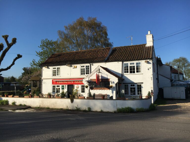 A white rendered country pub beside a road